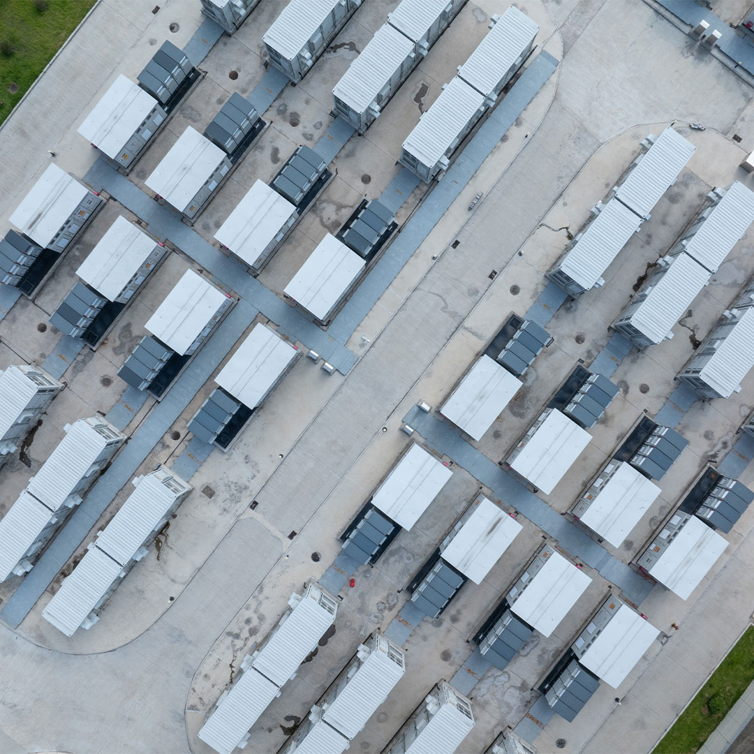 Aerial view of a large-scale battery energy storage facility with rows of containerized storage units