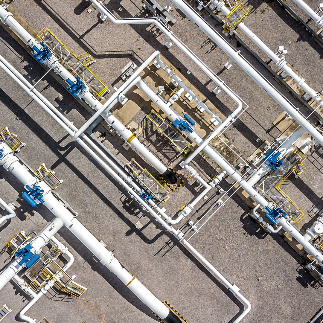 Aerial view of natural gas pipeline infrastructure with valves and distribution equipment at an energy facility