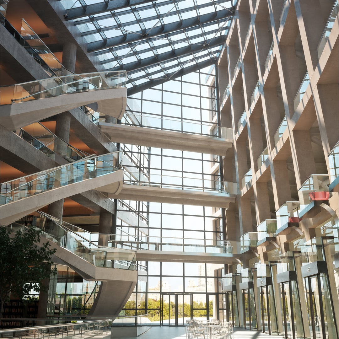 Interior of a modern building with multiple floors, angled glass walkways, and a glass ceiling allowing natural light.