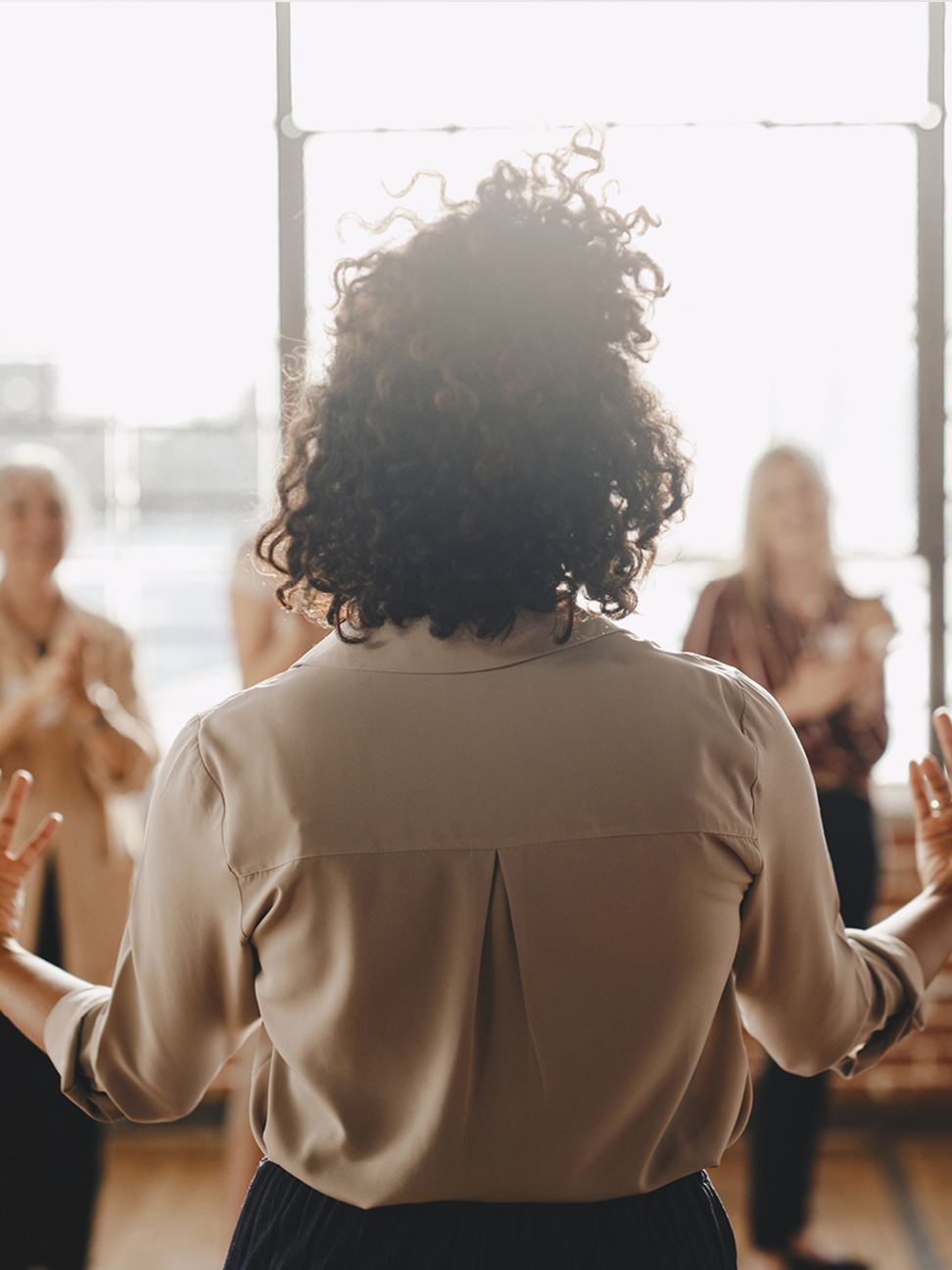 A woman speaking to other women