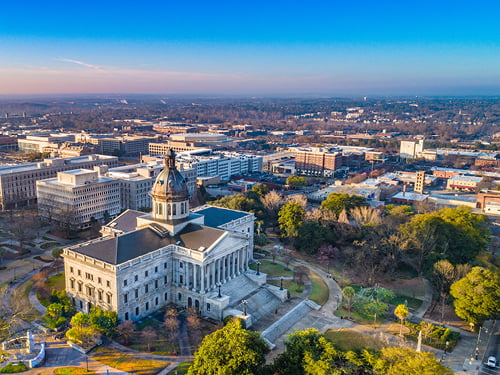 Aerial view of Columbia, SC downtown, featuring the State House and surrounding commercial buildings. Ideal location for businesses.