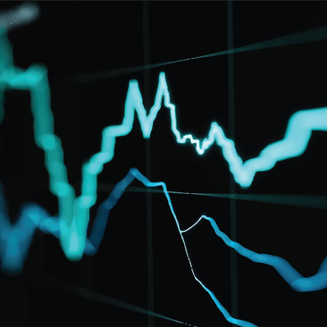 Close-up of glowing teal and blue financial line graphs on a dark digital screen