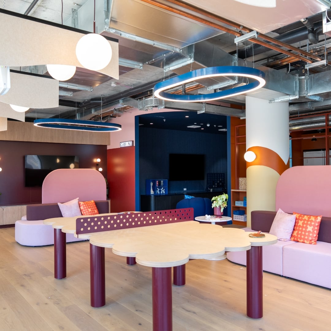 Contemporary communal lounge area at Scape Australia student accommodation, featuring colourful seating, collaborative tables and modern lighting designed for student socialising and study.