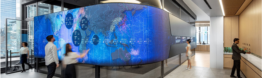 Office space with a curved digital wall showing global analytics and interactive visuals.