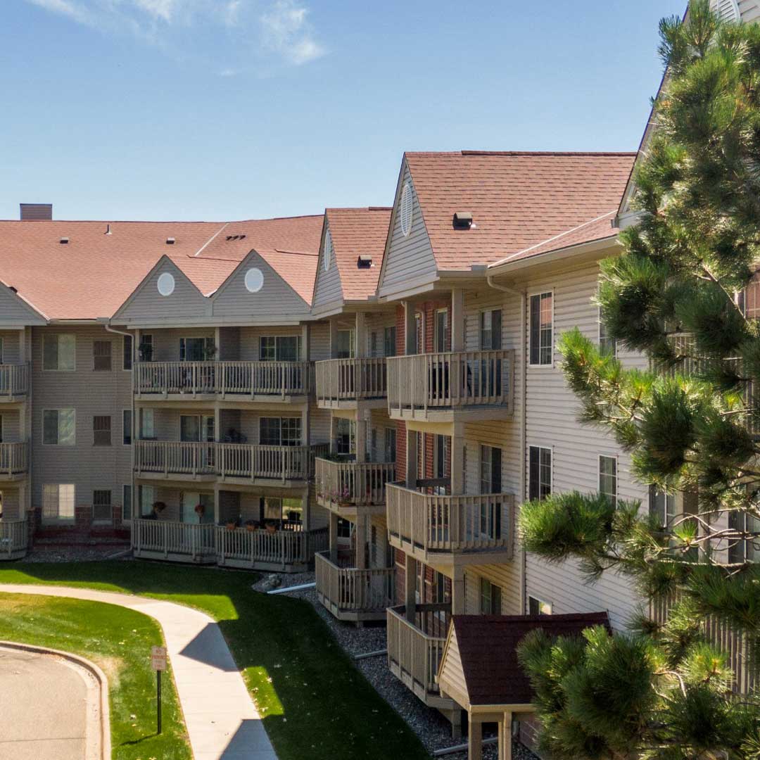 A light tan apartment building on a sunny day