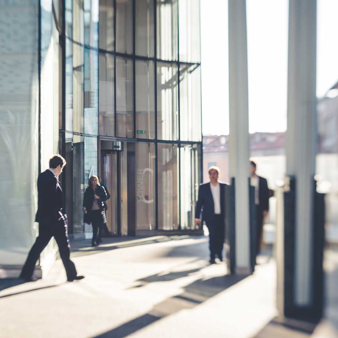 Office workers in front of an entrance to a building