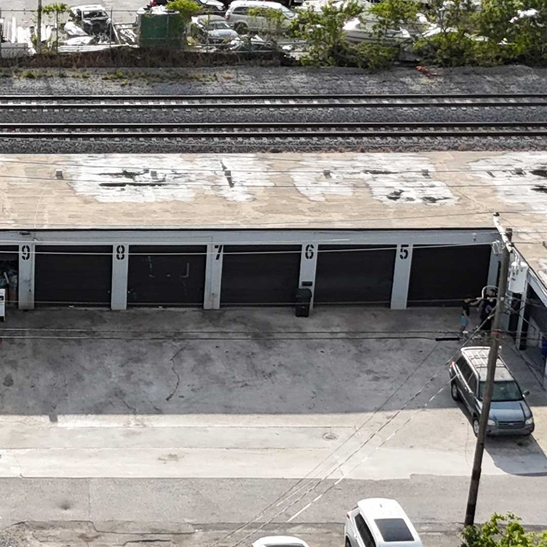 Exterior of building showing 5 bay garage doors