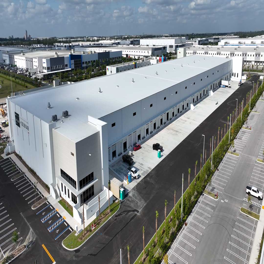 Exterior of one white industrial buidling