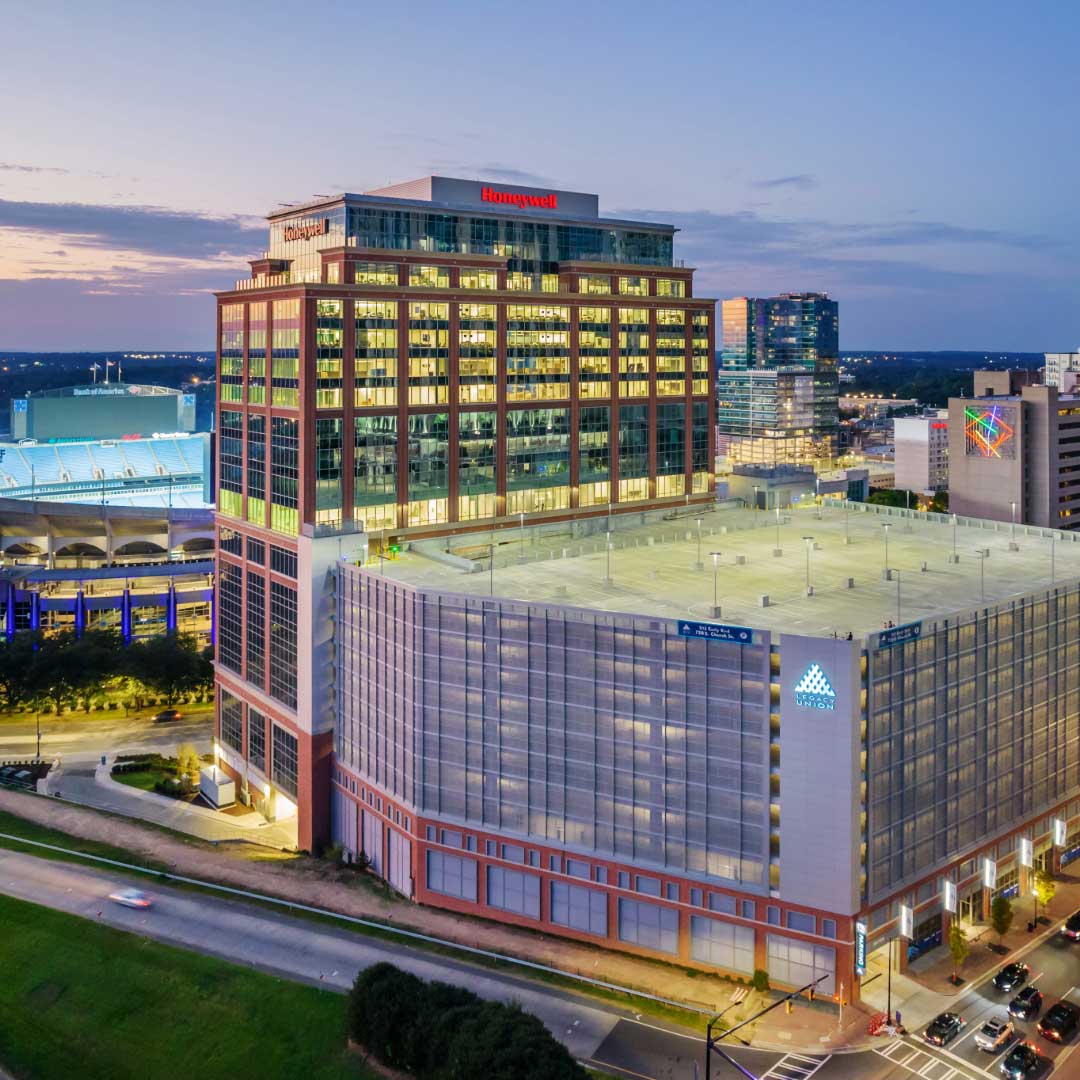 Cityscape at dusk with the Honeywell building, SEVEN20 parking garage, and stadium in the background.