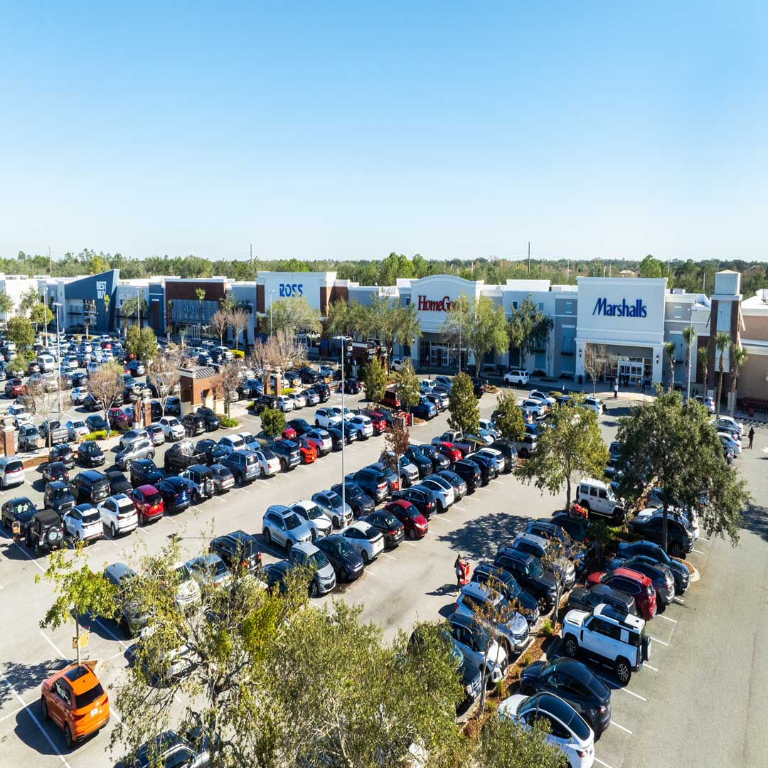 Ariel photo of retail center and parking lot full of cars