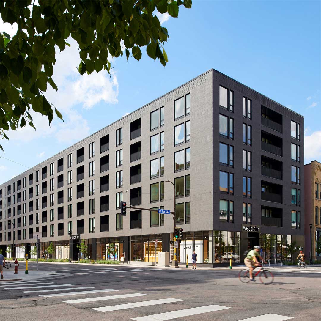 A tan urban multifamily building