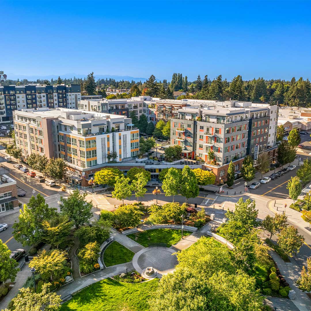 Aerial of apartment buildings surrounded by trees