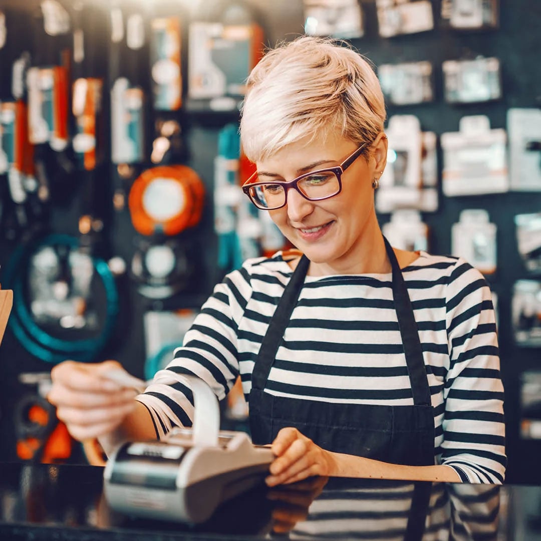 Cashier in retail store printing out receipt