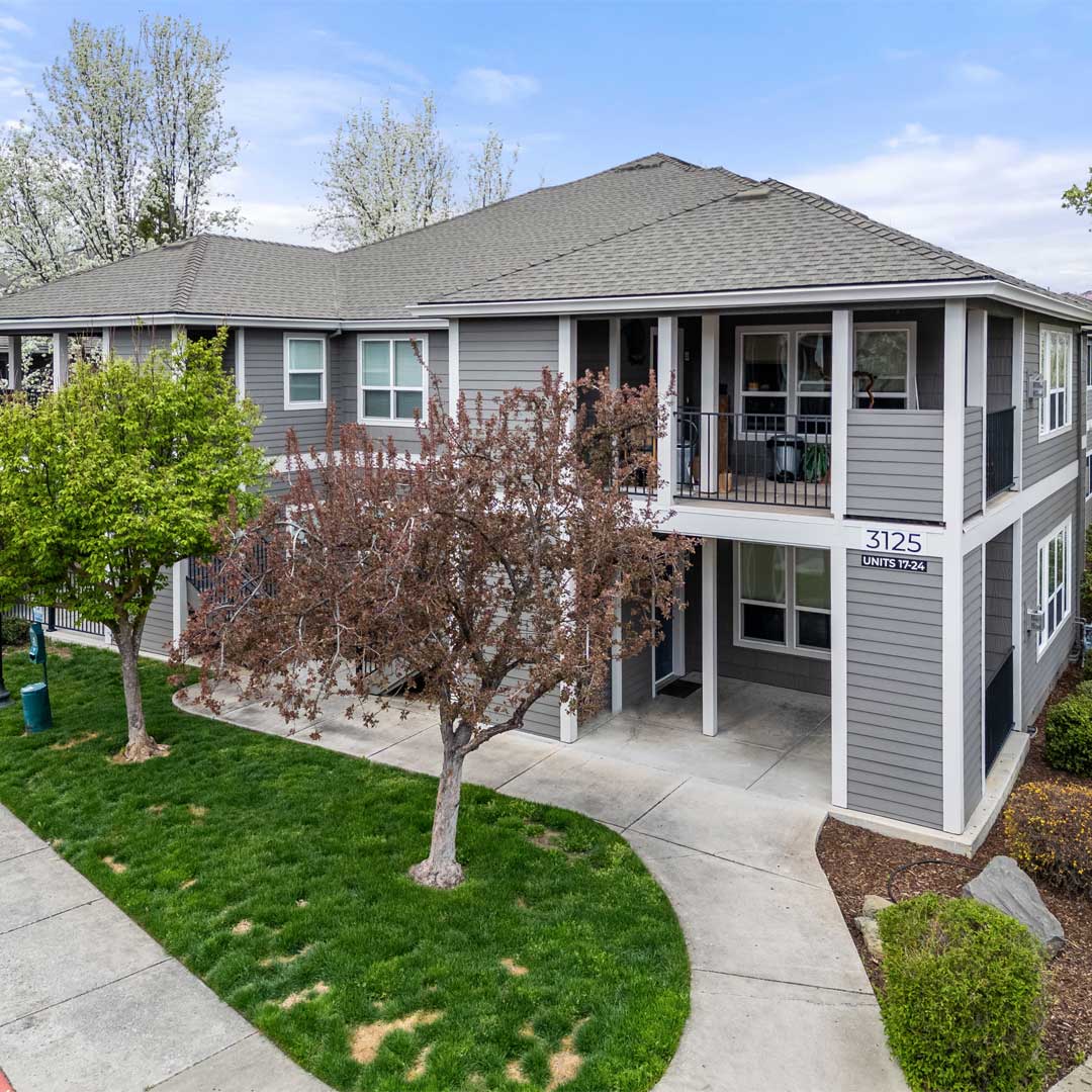 Exterior of multifamily property with trees surrounding