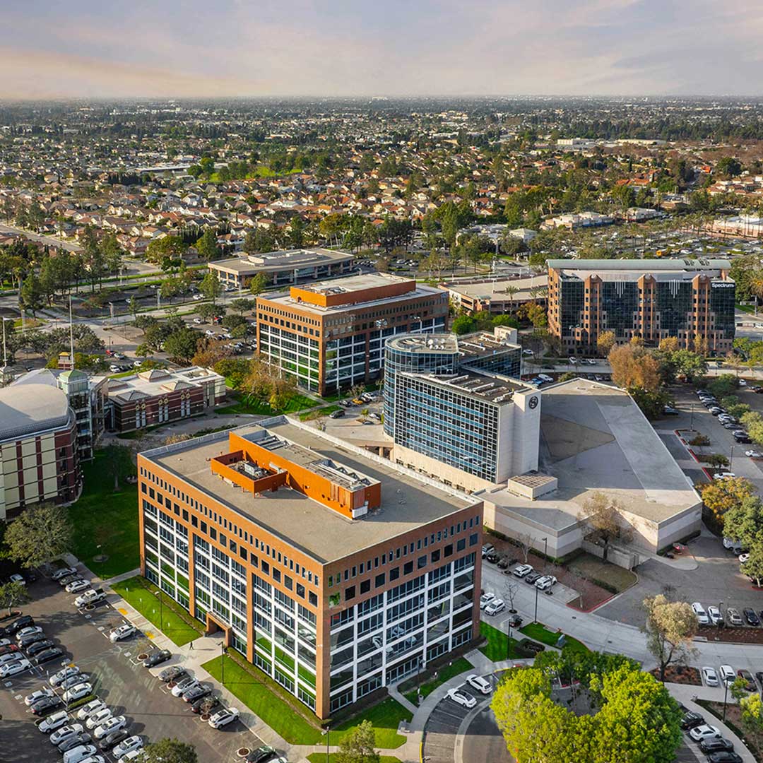 Aerial view of Cerritos Towne Center with modern office buildings and surrounding residential area.