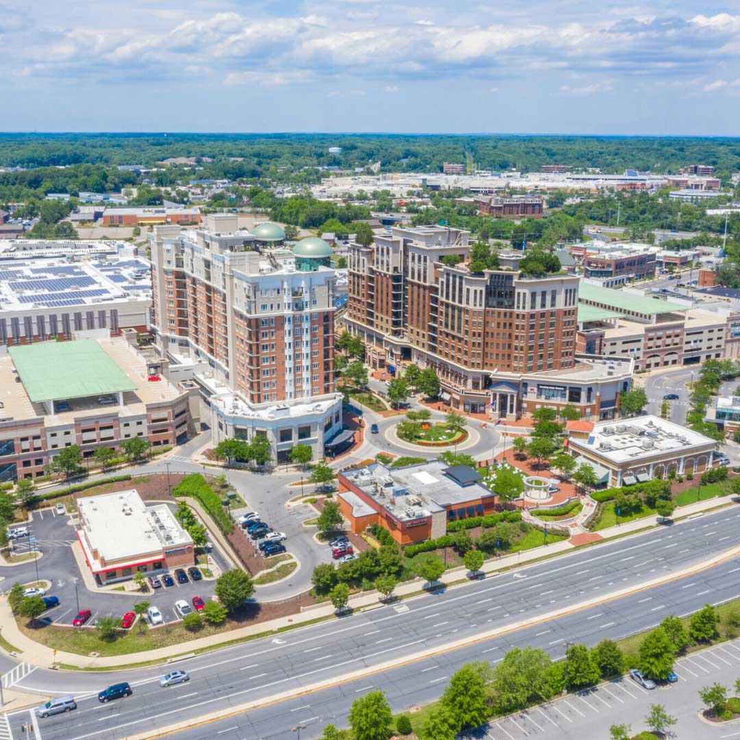 Aerial view of Annapolis Town Center featuring mixed-use buildings, retail spaces, and surrounding roads.