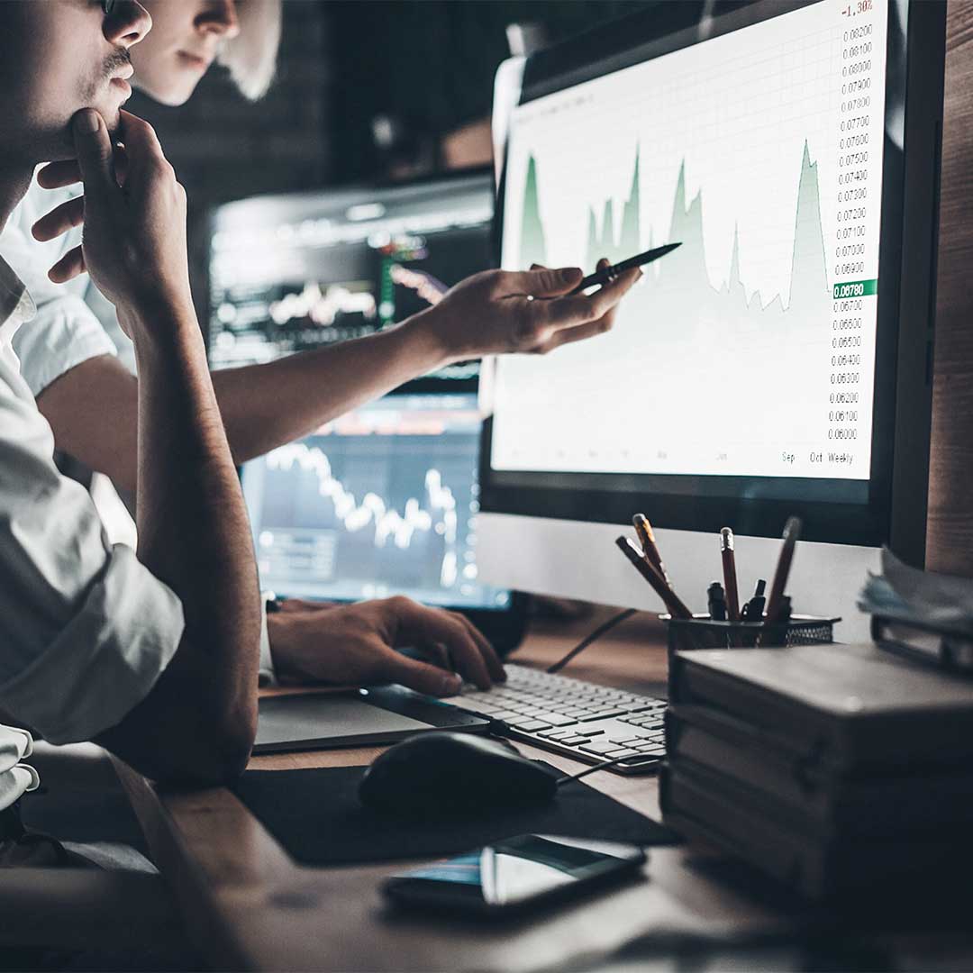 Person analyzing data on a computer screen.