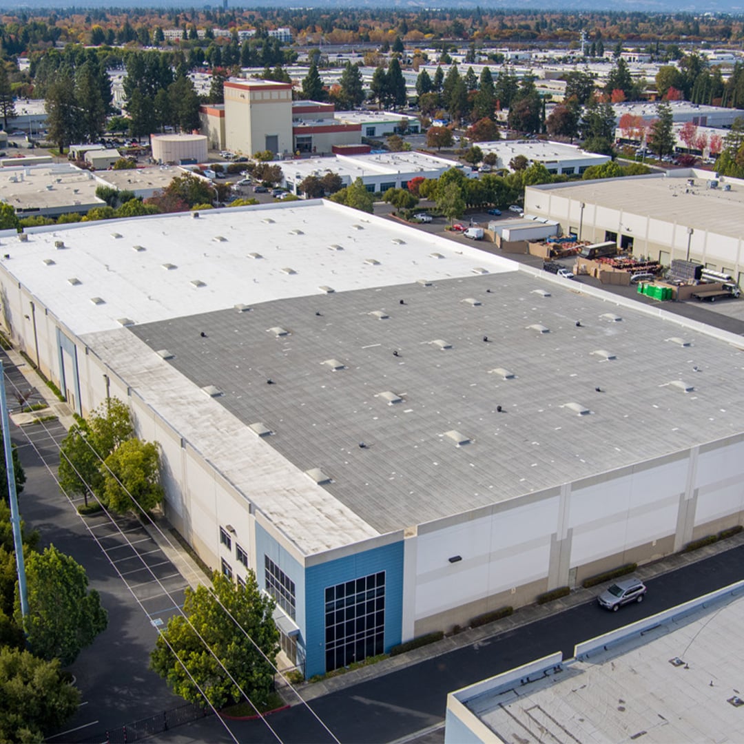Aerial view of a large single-tenant industrial warehouse facility in a San Jose business park