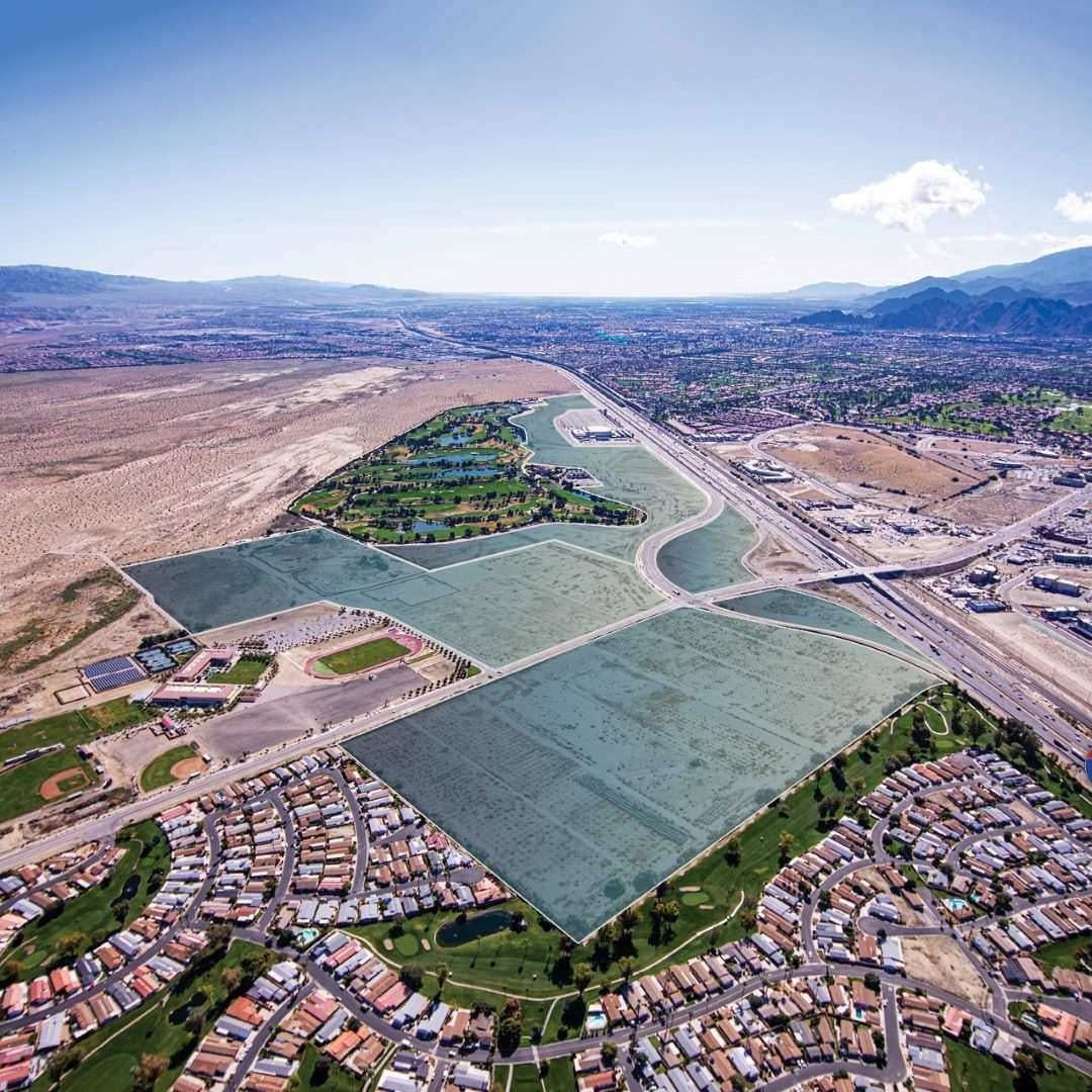 Aerial view of highlighted land parcels adjacent to Classic Club golf course in the Coachella Valley, California with freeway, residential, and mountain views