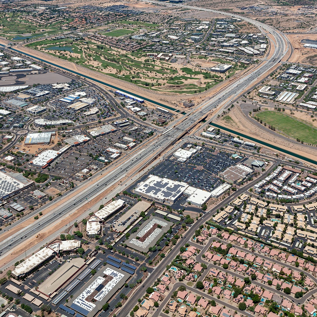 Aerial view of Scottsdale Towne Center retail shopping center Scottsdale AZ with highway access and surrounding residential neighborhoods