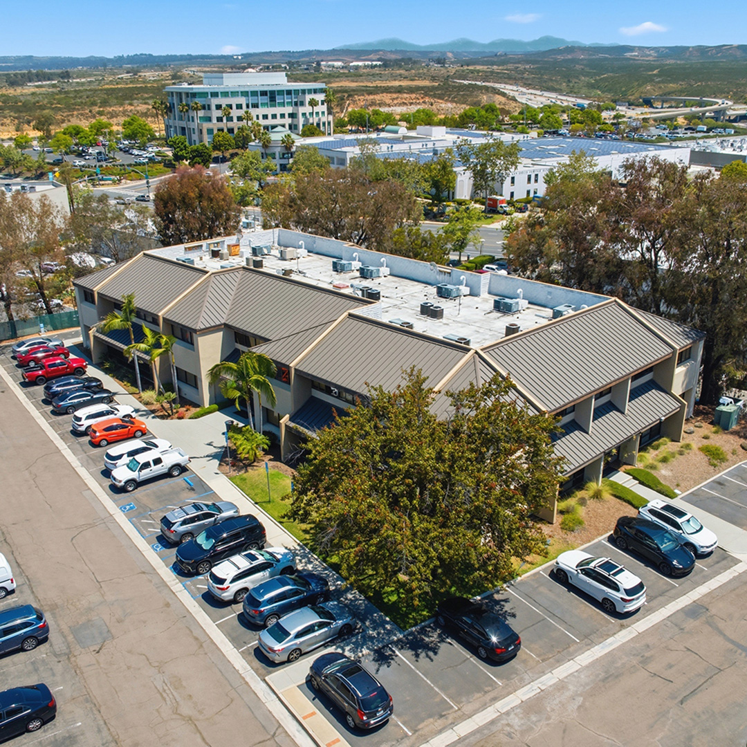 Aerial view of 9320 Chesapeake Drive, a multi-tenant office building in Kearny Mesa, San Diego, CA with ample surface parking.