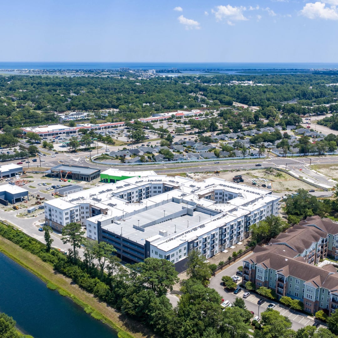Aerial view of CenterPoint mixed-use development in Virginia Beach with apartments, parking garage, retail, and waterfront