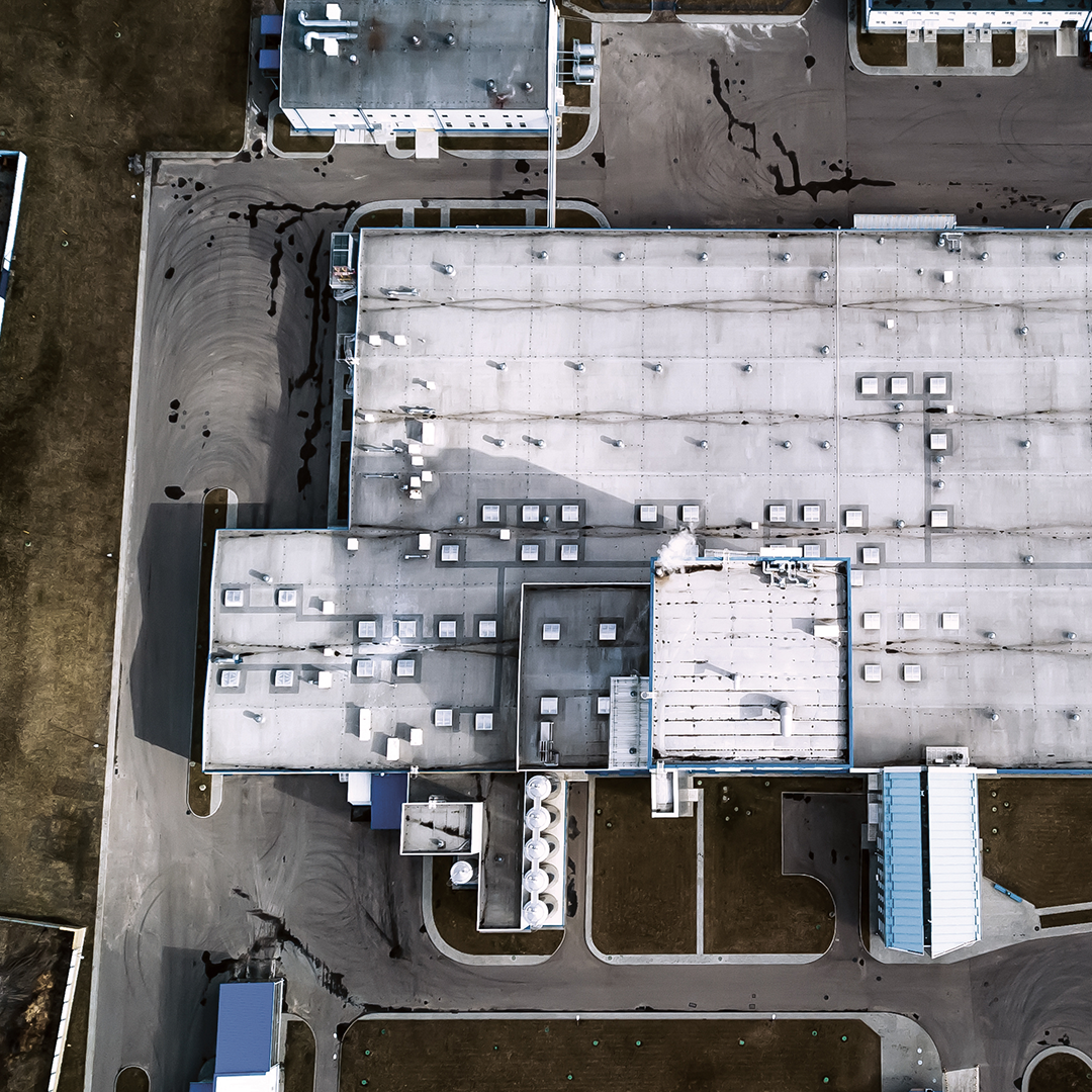 Aerial view of a large industrial and logistics warehouse facility representing CBRE's analysis of the largest U.S. industrial leases in the first half of 2026