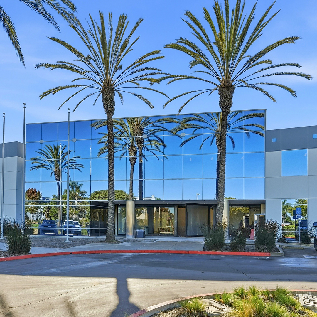 Exterior of 2081 Faraday Ave, a 157,973-square-foot single-tenant industrial corporate headquarters in Carlsbad, California, sold for $45 million by CBRE
