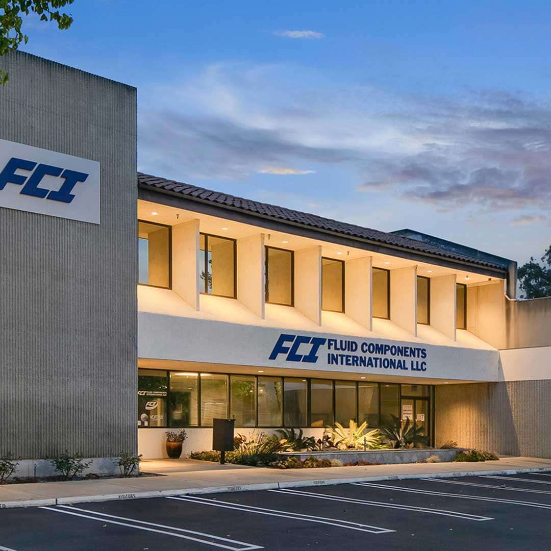FCI Fluid Components International LLC headquarters building exterior at dusk, San Marcos, CA industrial campus