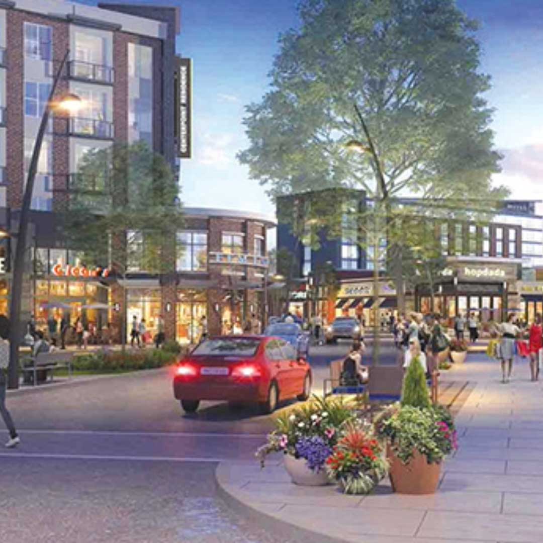 Modern mixed-use retail district with vibrant street view, shops, outdoor seating, landscaped walkways, and active urban lifestyle scene at dusk.