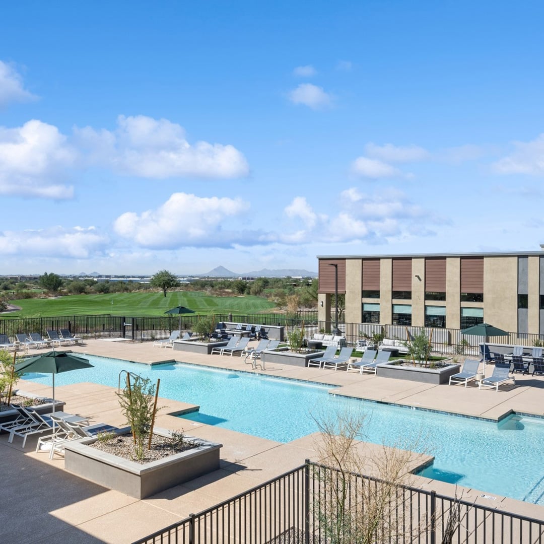 Resort-style pool deck at Ascend at Longbow Highpoint multifamily community in Mesa, Arizona, with lounge seating and views of Longbow Golf Club, sold by CBRE