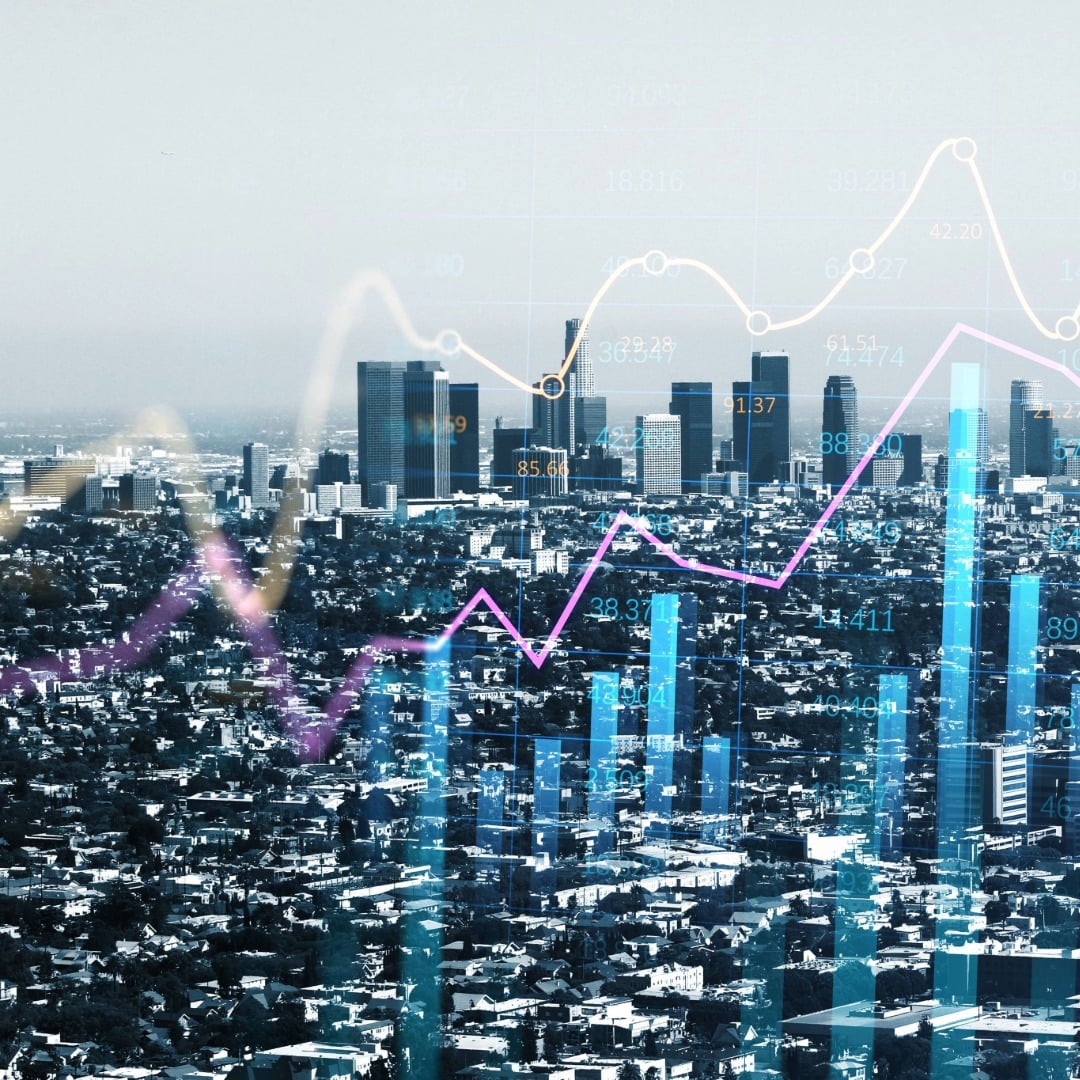 City skyline with overlaid financial charts representing increased commercial real estate lending activity in the U.S. during Q1 2026, according to CBRE research.