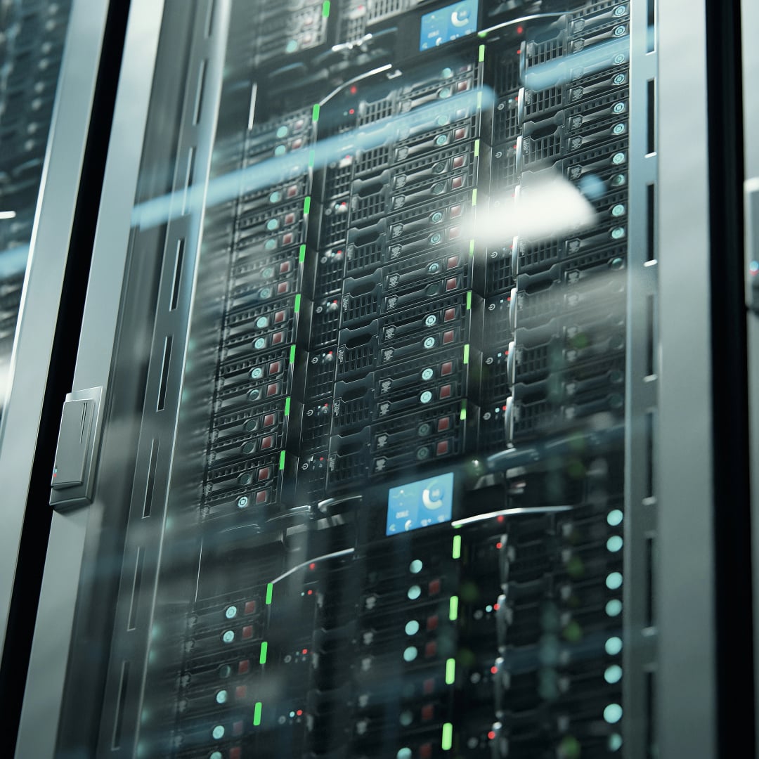 Close-up of rack-mounted servers inside a locked glass data center cabinet with green and red indicator lights