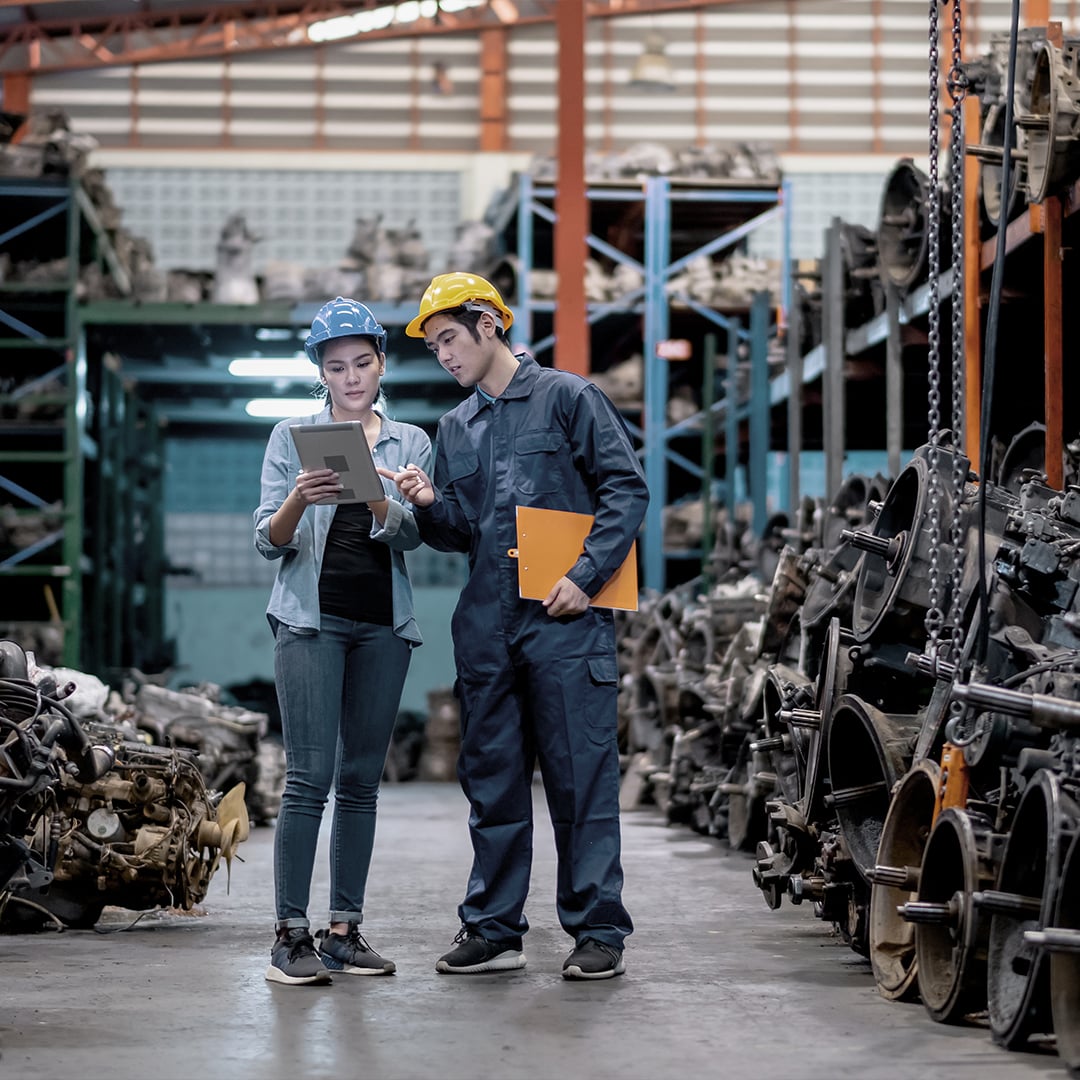 two automotive factory engineers