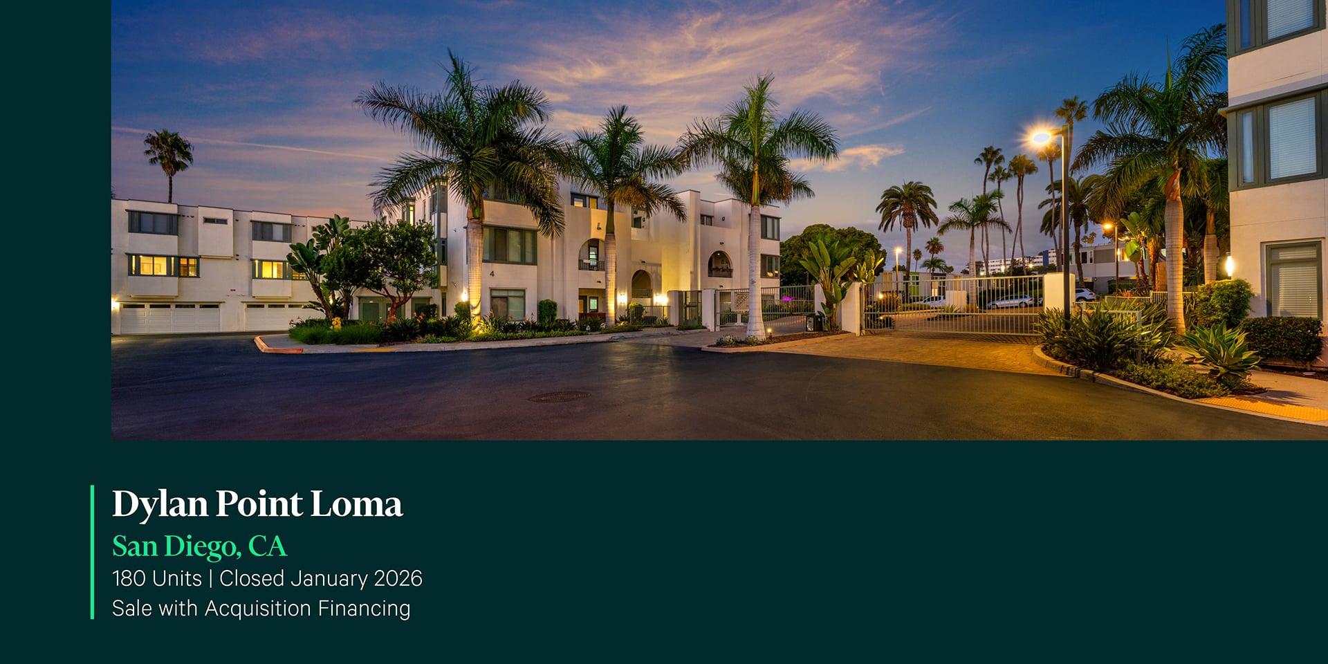 Twilight exterior of Dylan Point Loma 180-unit apartment community in San Diego, CA featuring white stucco buildings, palm trees, and gated entry.