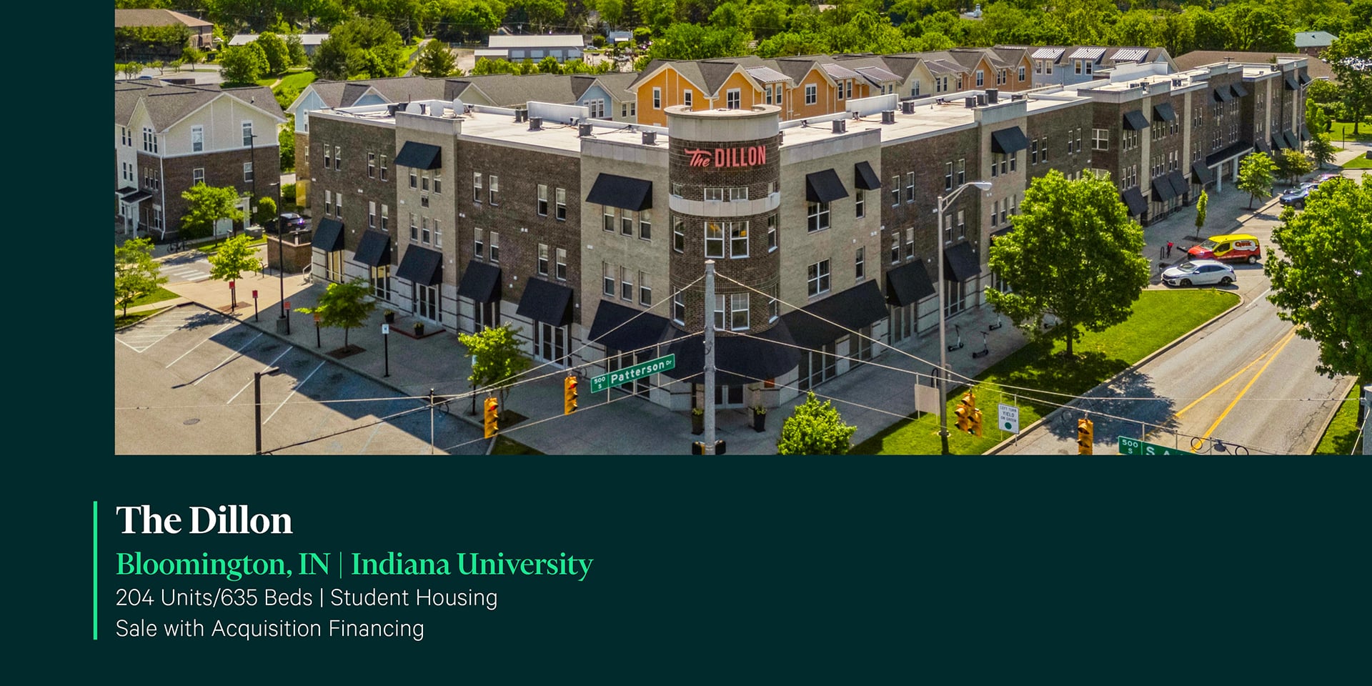 Aerial exterior of The Dillon student housing community near Indiana University in Bloomington, IN featuring brick facade and corner tower signage.