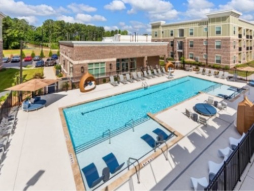 Resort‑style swimming pool and amenity deck at Ardmore at Flowers apartments