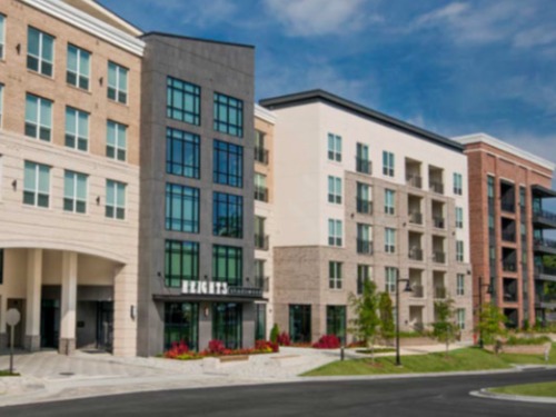 Mid‑rise multifamily apartment building with modern façade at Heights at Shadowood