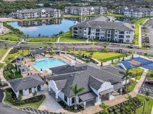 Aerial view of Parkside Punta Gorda apartments with pool, clubhouse, and lake