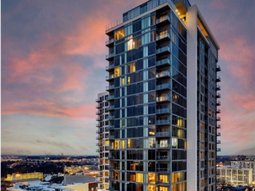 High‑rise multifamily residential tower with city views at Sora at Spring Quarter