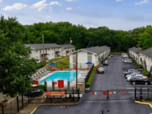 Gated apartment community with swimming pool and parking at The Westlight Apartments