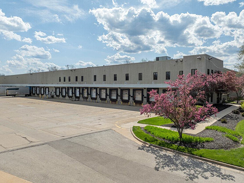 Industrial warehouse at 6575 Davis with multiple loading docks, large truck court, and landscaped exterior.