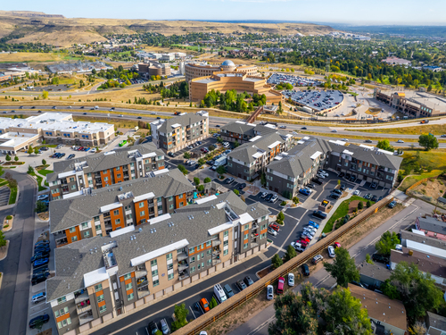 Aerial view of Outlook Golden Ridge apartment community in Golden, Colorado with multi-story residential buildings, parking, and surrounding foothills landscape