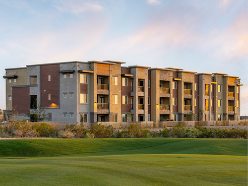 Exterior view of Ascend at Longbow Highpoint, a modern multifamily apartment community with contemporary buildings and landscaped green space.